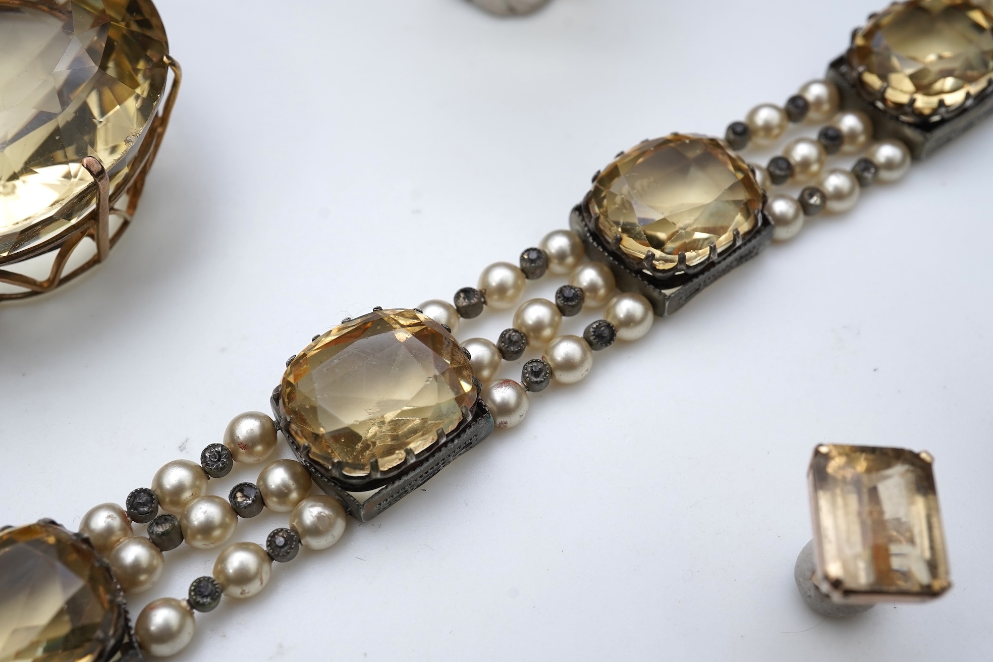 A collection of citrine jewels and a paste bracelet